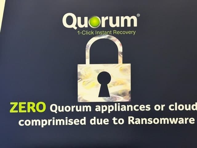 Text reading "Quorum 1-Click Instant Recovery" at the top, with a padlock icon below it. Underneath, it says "ZERO Quorum appliances or cloud compromised due to Ransomware" in white and bright green text. The background is a solid dark color.